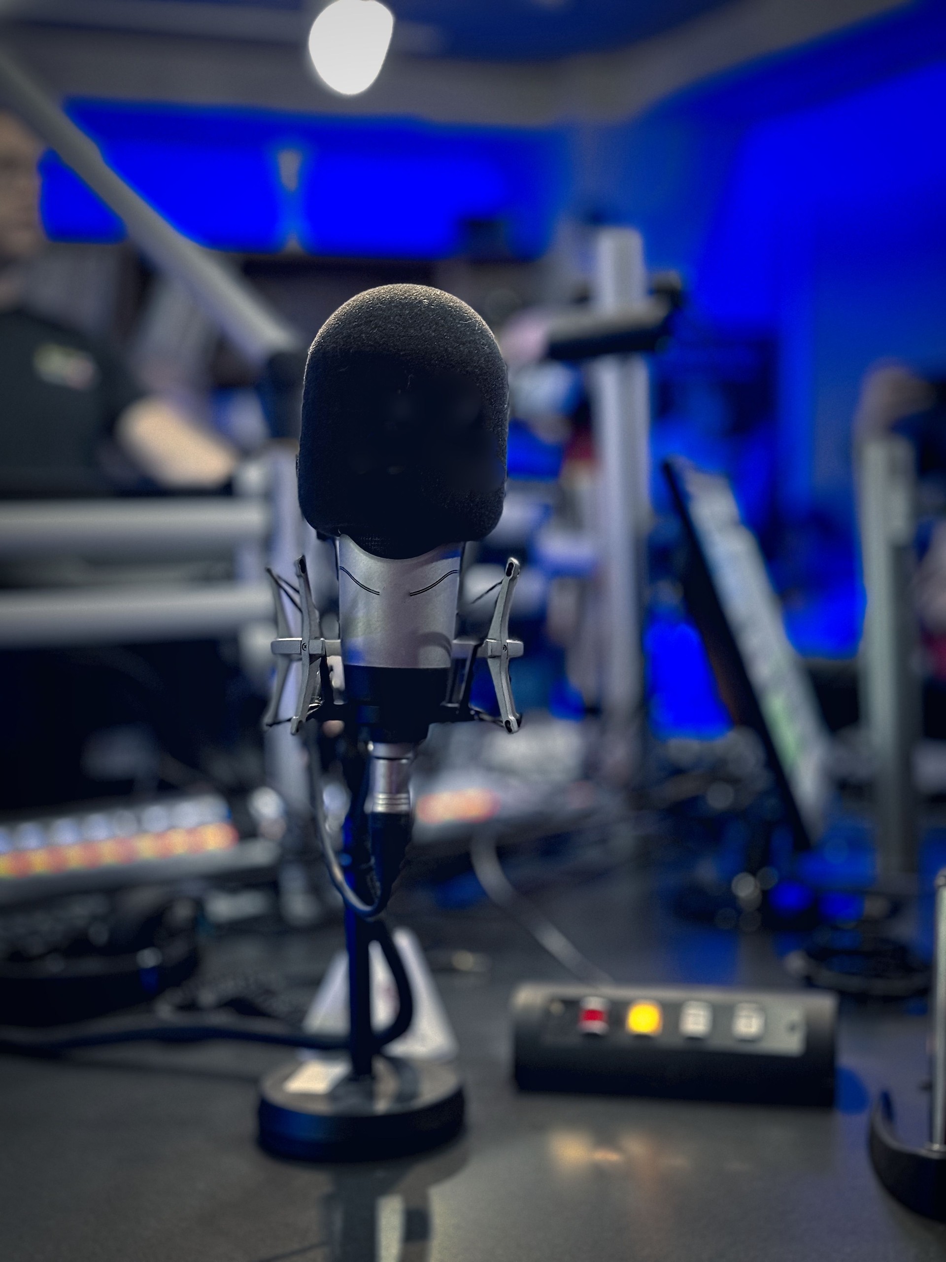 Professional microphone in recording studio with blue lighting